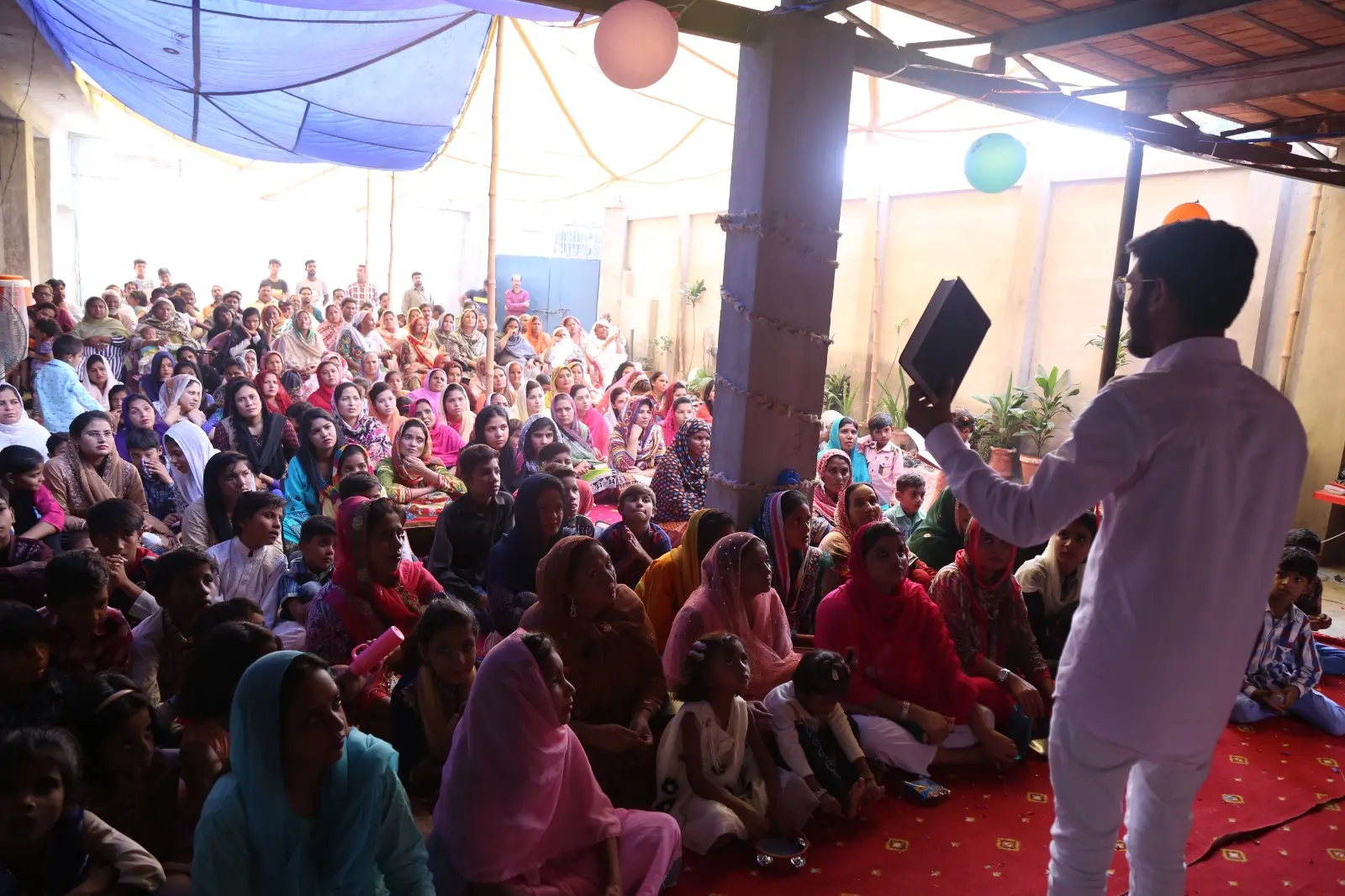 Evangelist Daud Ayub preaching to a community gathering