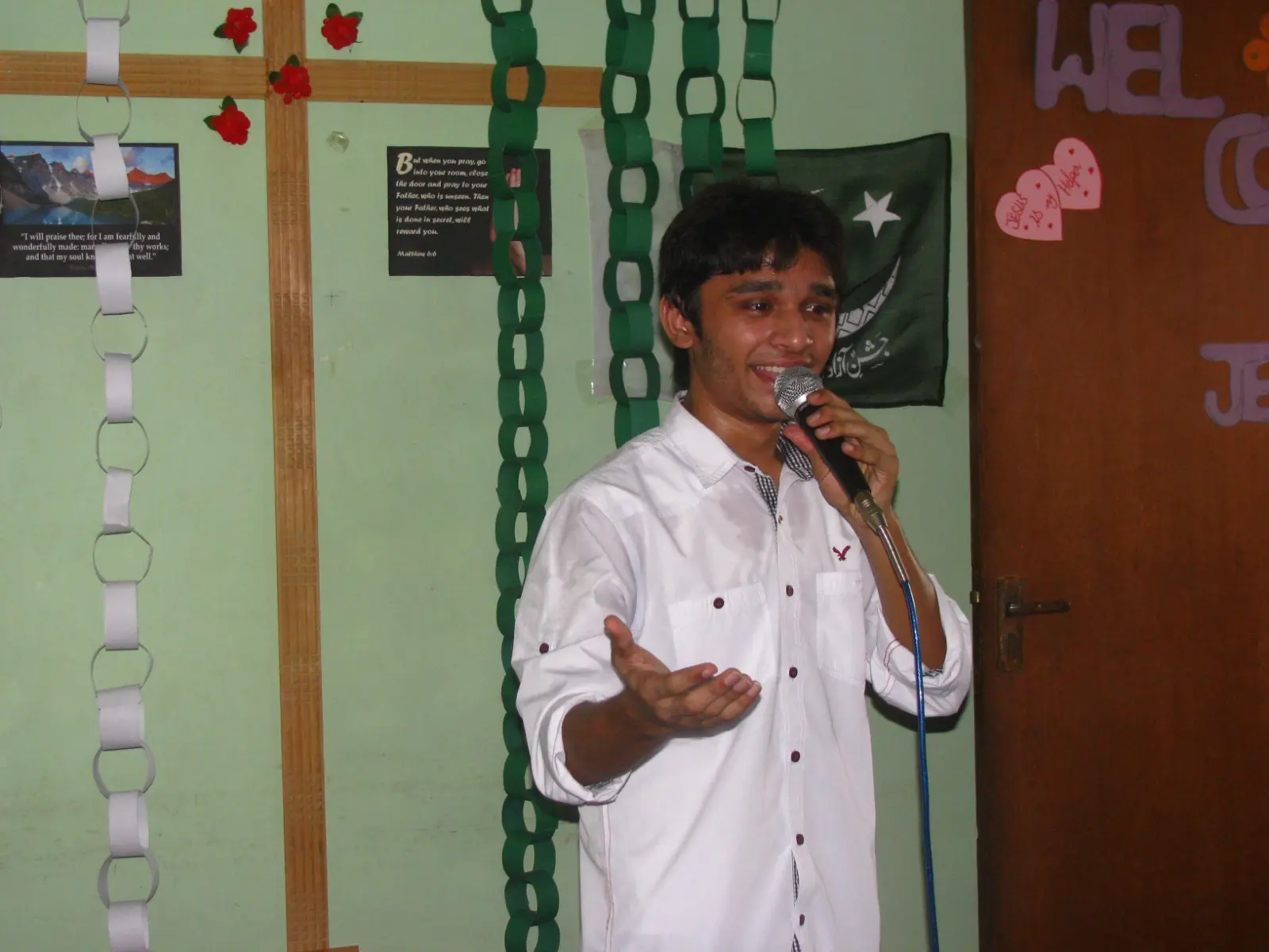 Daud Ayub speaking at an indoor Christian gathering