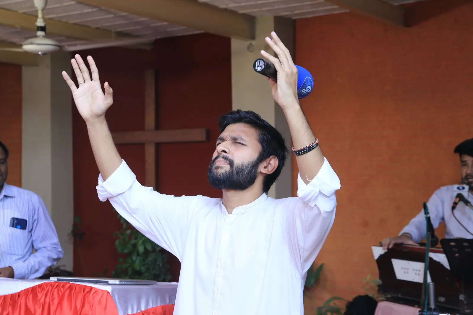 Evangelist Daud Ayub worshipping during a ministry gathering